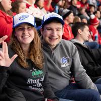 Two alumni smile for a photo together at the Detroit Red Wings GVSU Night
